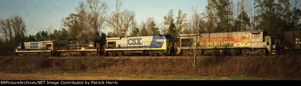 CSX 5561 B30-7 CSX 1900 X-SCL 300 U18B CSX 3003B BQ23-7 X-SBD 5133 XX-SCL Family Lines 5133 CSX 3118 X-SBD 5118 XX-L&N Family Lines B23-7 take a manifest north from Bainbridge Georgia along highway 84 01-1994